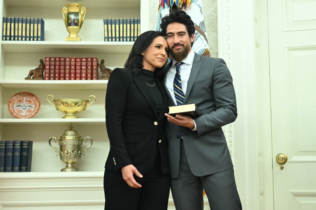 Tulsi Gabbard and her husband, Abraham Williams, embrace in the Oval Office.