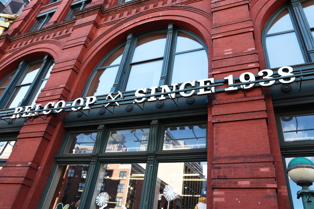 REI Co-op store signage and facade on a brick building in New York City.