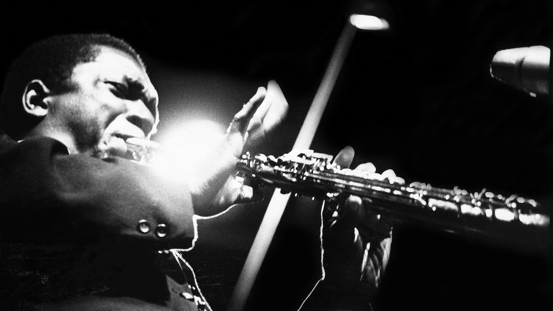 John Coltrane performs on stage at the Half Note club, New York, 1965. (Photo by Adam Ritchie/Redferns)
