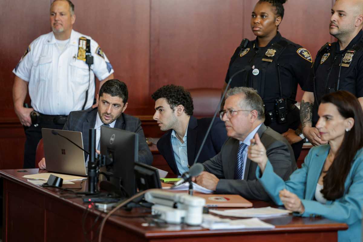 Luigi Mangione converses with his legal team during a suppression hearing at the Manhattan Supreme Court on May 18, 2026. 