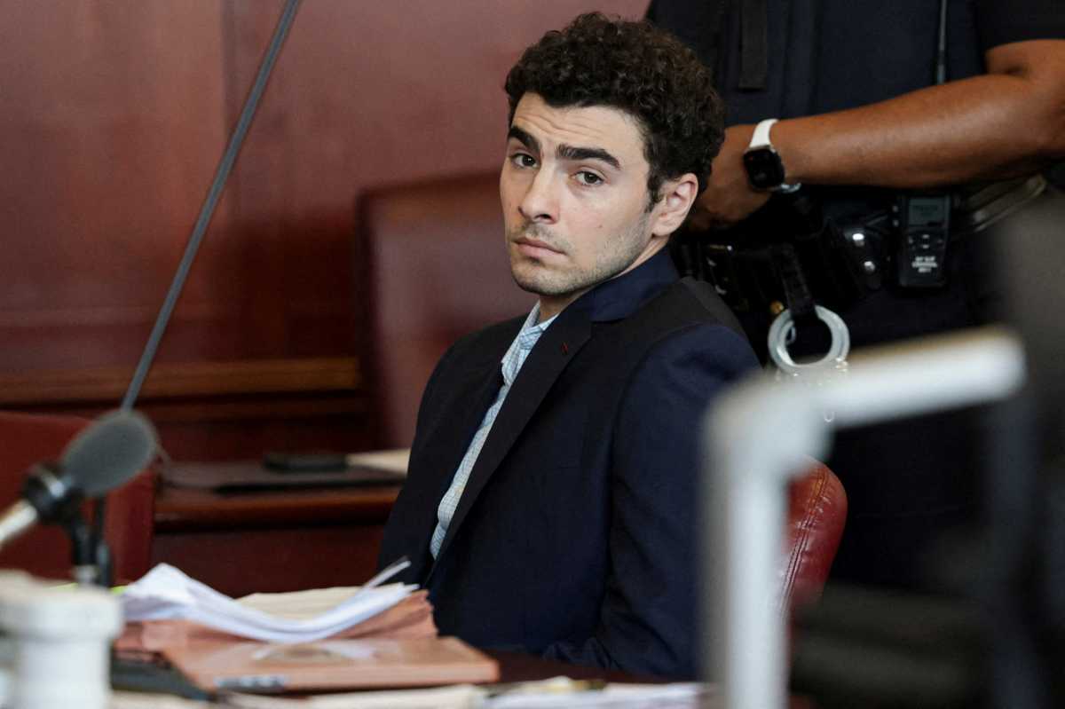 Luigi Mangione mugs for the camera during hearing in murder trial