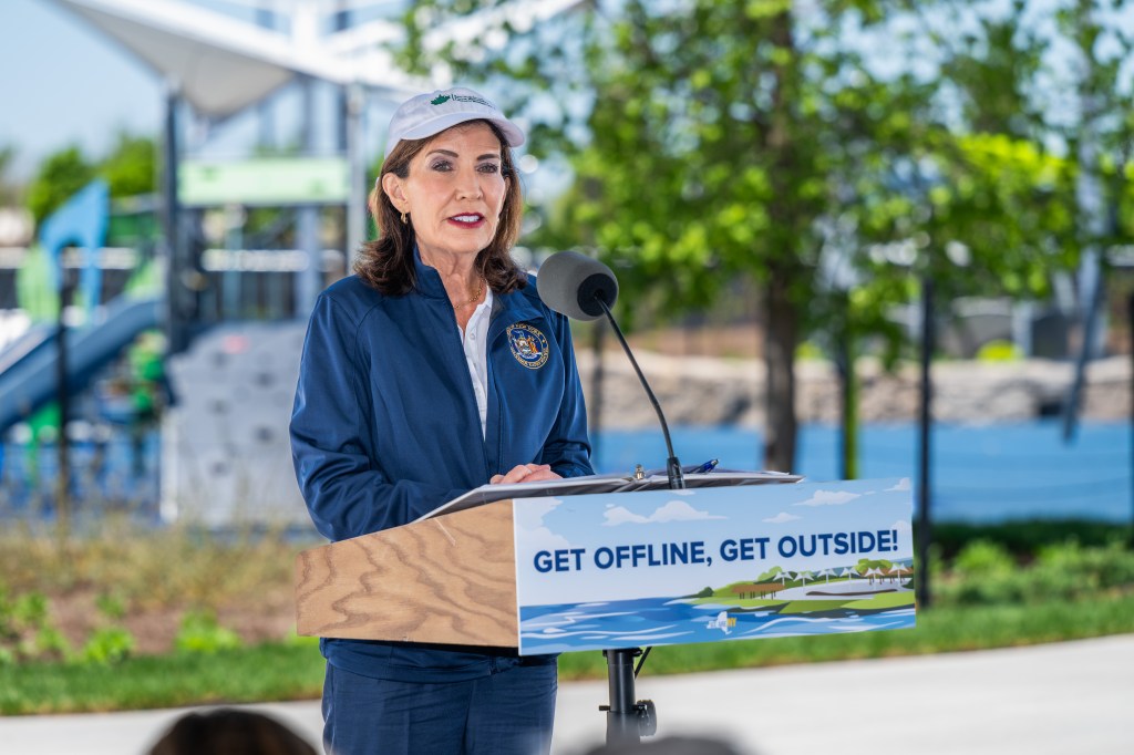 Governor Hochul at a podium with a sign that reads "Get Offline, Get Outside!".