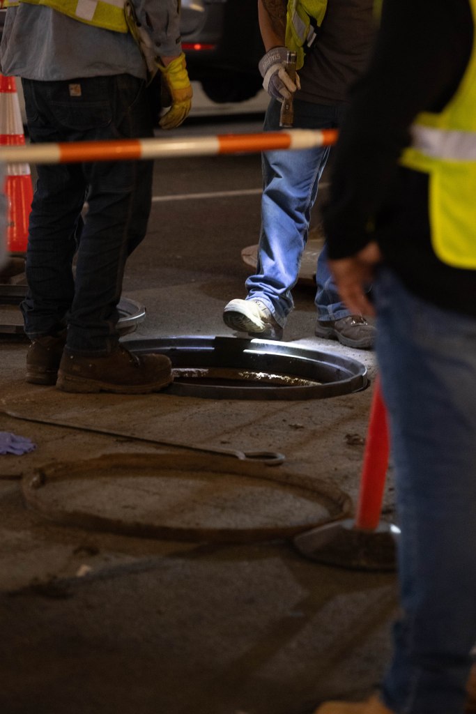 Con Edison workers investigating a manhole.