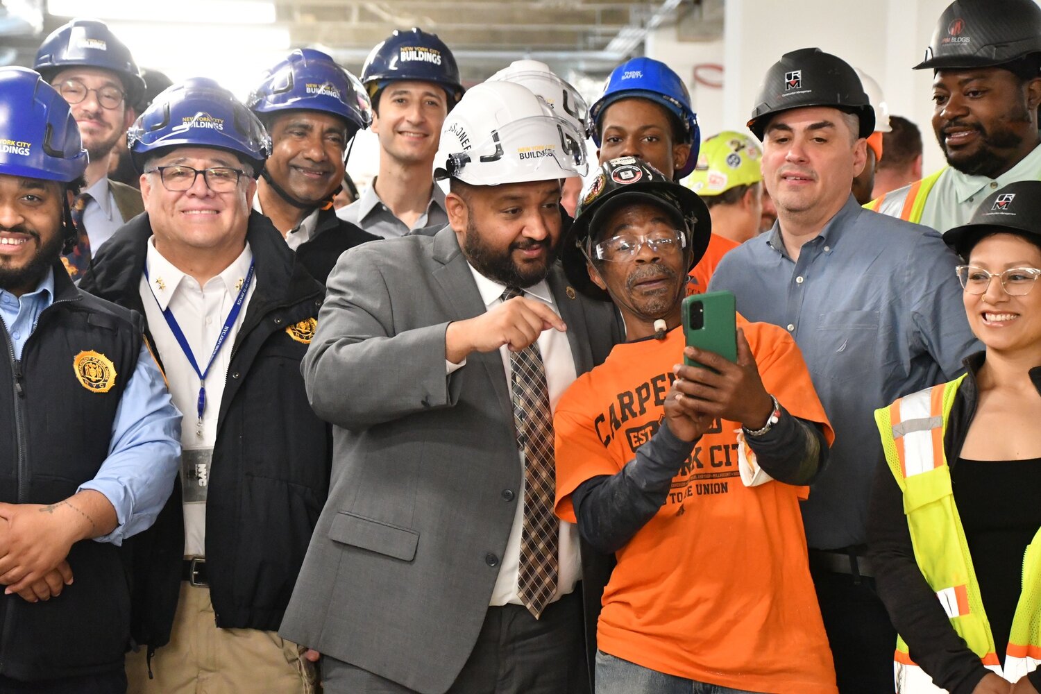 DOB Commissioner Ahmed Tigani taking a selfie with construction workers May 13 during construction safety week. Commissioner Tigani spoke with The Chief to discuss expanding worker protections under the new initiative.