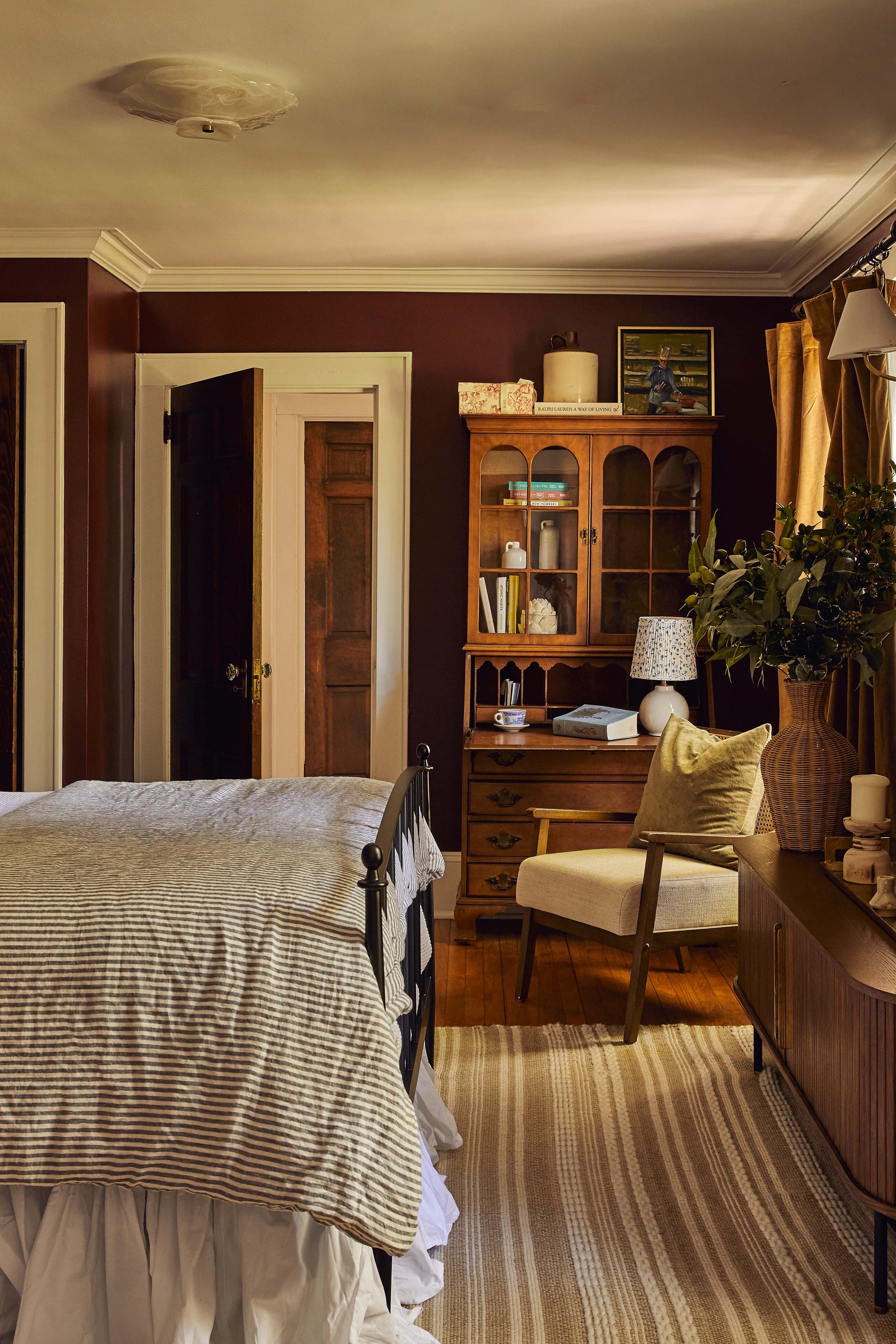 Cozy bedroom with vintage furniture and warm tones.