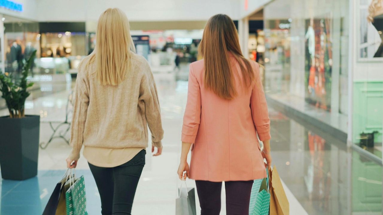 two women walking through a shopping mall