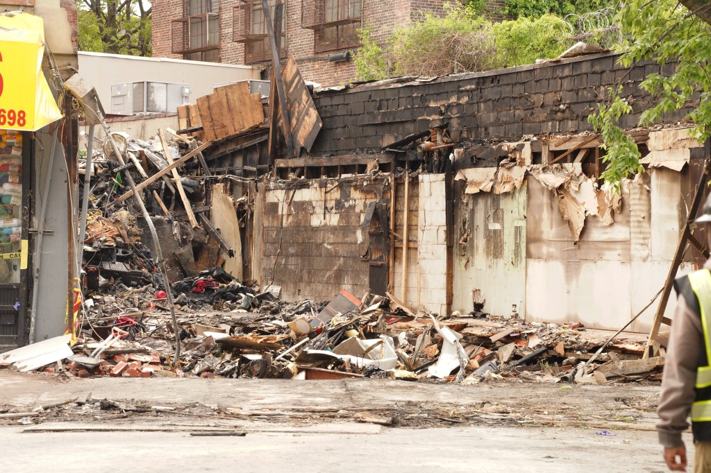 The charred remains of a two-story building in Bronx, New York, following a fatal fire.