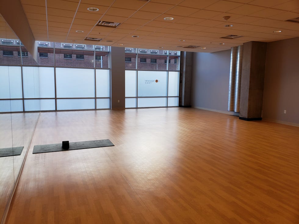 Yoga studio with wooden floor and large windows