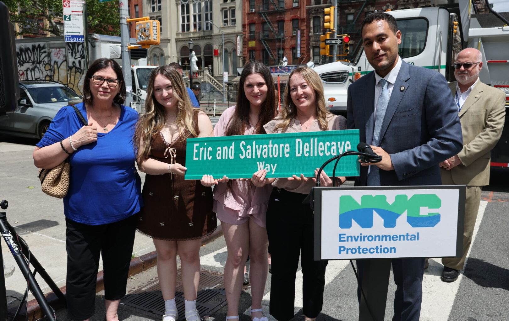 Street renaming sign with family members of father and son at the dedication ceremony