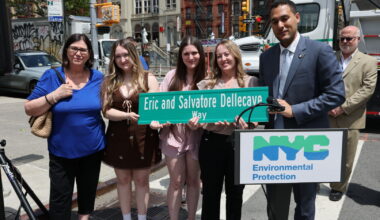 Street renaming sign with family members of father and son at the dedication ceremony