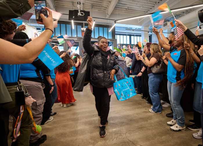 Customers greeted by staff at the new Manhattan flagship. Photo via Allison Worldwide.