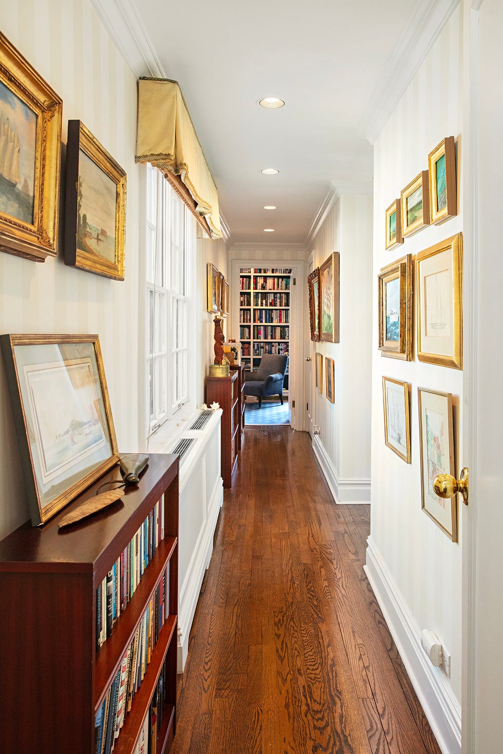 Hallway with paintings and bookshelves Hallway with paintings and bookshelves