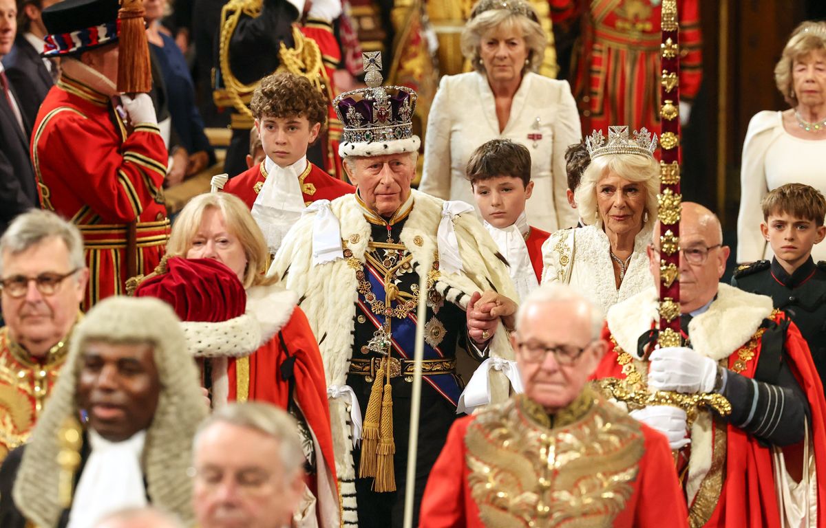 King Charles III and Queen Camilla process into the Lord's chamber during the state opening of Parliament