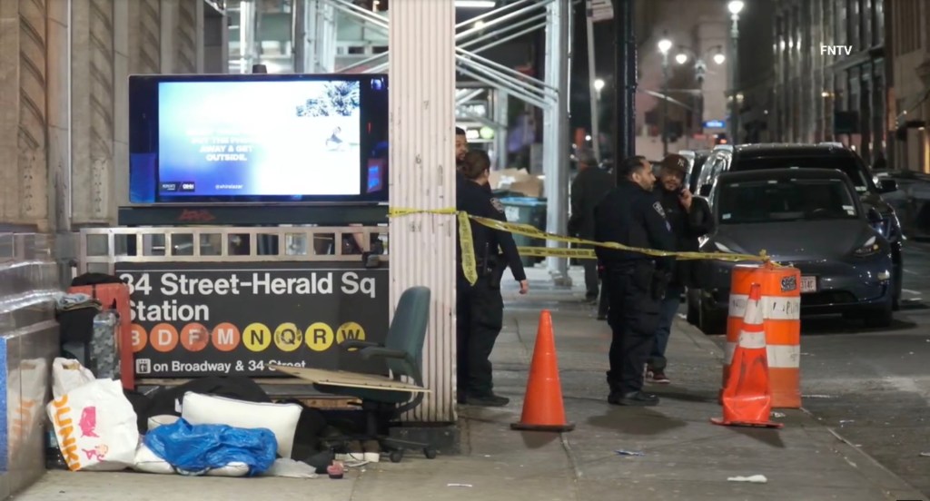 Caution tape surrounding the crime scene with cops there.