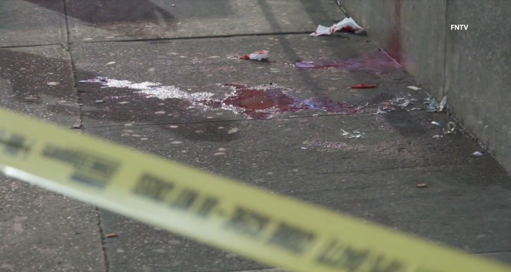 Pictures from the scene show blood splats on the sidewalk. 