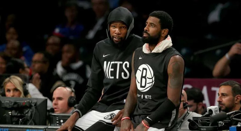 Oct 3, 2022; Brooklyn, New York, USA; Brooklyn Nets forward Kevin Durant (7) and guard Kyrie Irving (11) wait to check into the game against the Philadelphia 76ers during the second quarter at Barclays Center. Mandatory Credit: Brad Penner-USA TODAY Sports