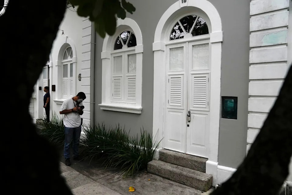 A journalist films the entrance to the apartment where Brent Sikkema, an American art dealer, was found dead, in Rio de Janeiro, Jan. 18, 2024. / Credit: Silvia Izquierdo / AP