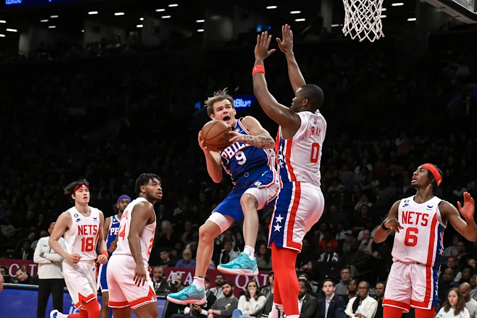 Apr 9, 2023; Brooklyn, New York, USA; Philadelphia 76ers guard Mac McClung (9) takes a shot against Brooklyn Nets forward RaiQuan Gray (0) during the second quarter at Barclays Center. Mandatory Credit: John Jones-USA TODAY Sports