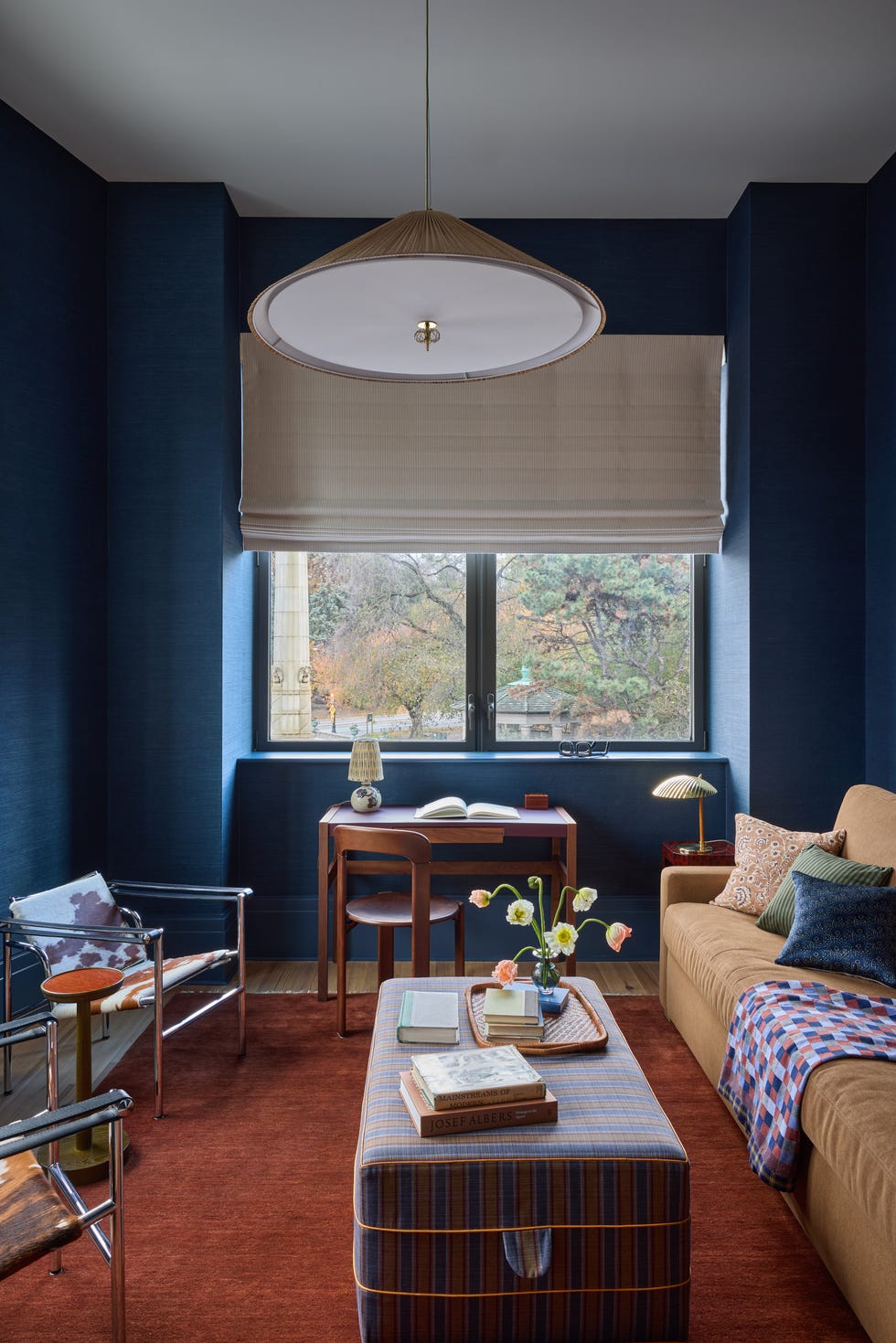 Cozy living space with desk, seating, and decor.