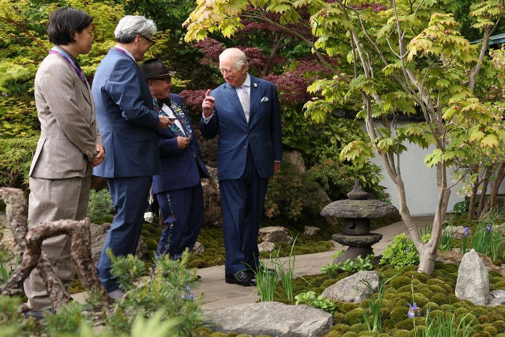 Britain's King Charles III (R) reacts as he talks with designer Kazuyuki Ishihara (2R) in the Tokonoma Garden -