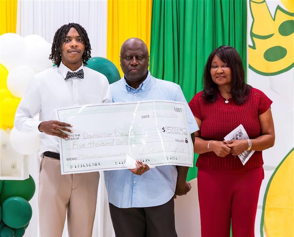 Damarion Douglas receives one of Patrick Queen's inaugural athletic scholarship awards for...
