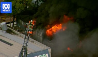 Public urged to stay inside as fire crews battle blaze at tyre shop south of Brisbane
