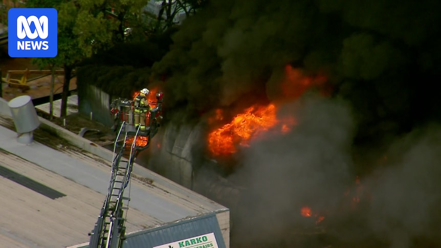 Public urged to stay inside as fire crews battle blaze at tyre shop south of Brisbane