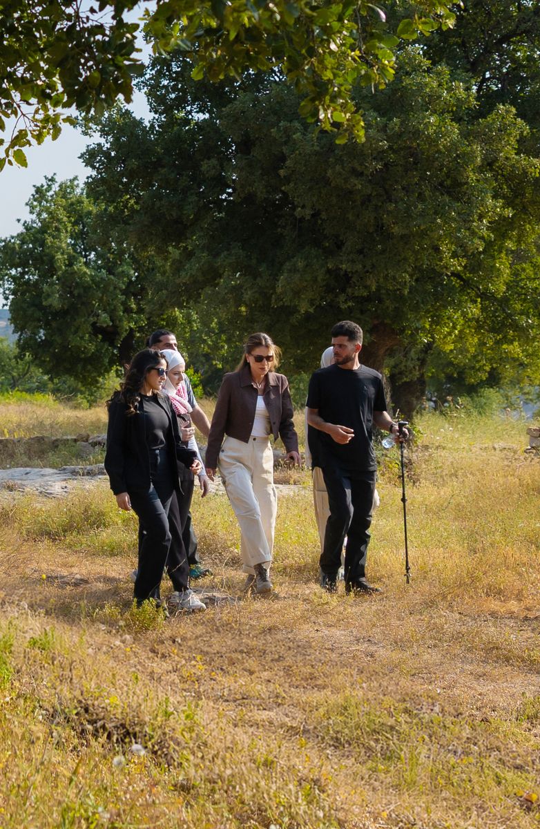 Queen Rania's outfit struck a careful balance between function and style, with clean lines and neutral tones that complemented the natural surroundings. 