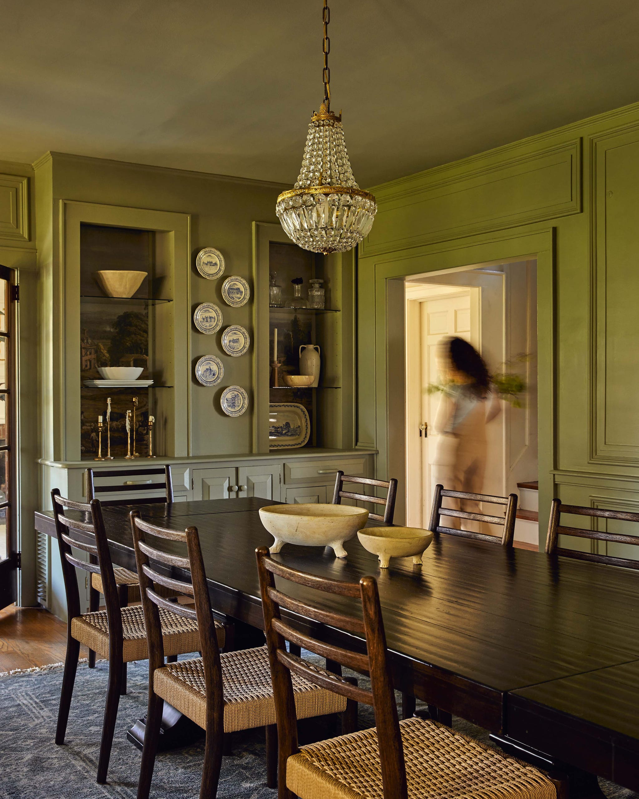 Dining area with a large table and decorative elements.