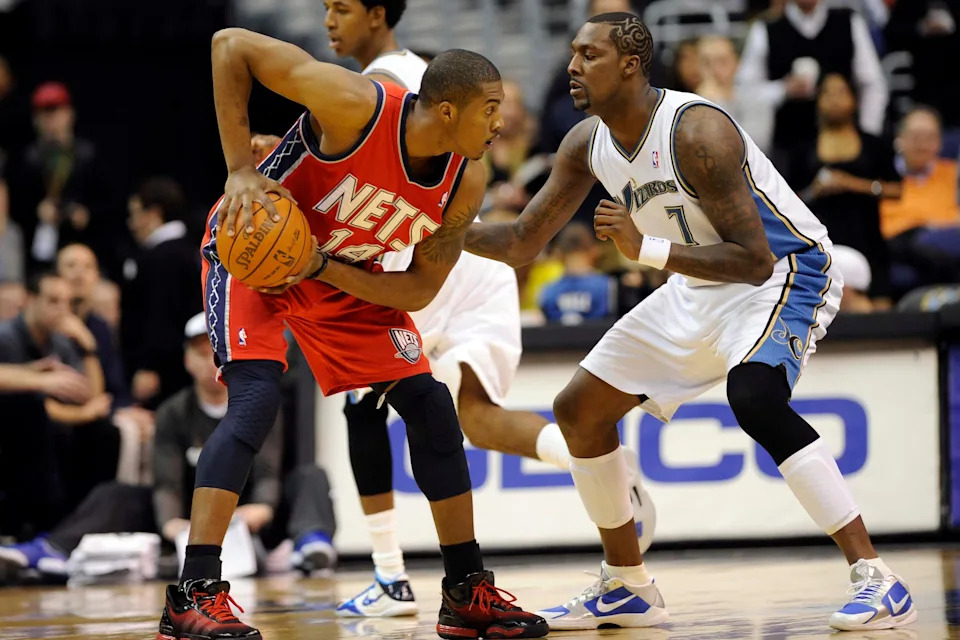 Jan 7, 2011; Washington, DC, USA; New Jersey Nets power forward Derrick Favors (14) looks to drive past Washington Wizards power forward Andray Blatche (7) during the first half at the Verizon Center. Mandatory Credit: Rafael Suanes-USA TODAY Sports