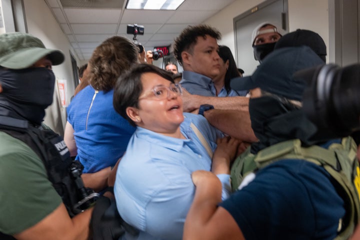 A Paraguayan woman whose relative was detained is surrounded by federal agents at the Jacob K. Javits Federal Building on July 16, 2025, in New York City. Various council members and a state senator attended immigration hearings and observed Immigration and Customs Enforcement as they continued their stepped-up tactics of detaining people during routine check-ins or showing up to court for their immigration hearings.