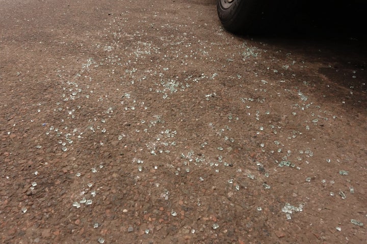 A day after Diego’s arrest in Corona, glass from his car window lay strewn across the pavement. Feb. 17, 2026. Credit: Gwynne Hogan/THE CITY