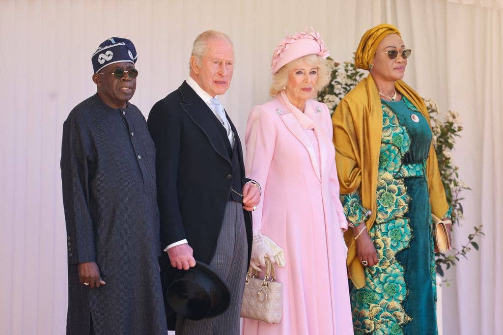 Queen Camilla in pastel pink coat dress beside president of the Federal Republic of Nigeria Bola Ahmed Tinubu, King Charles III, and first lady of nigeria