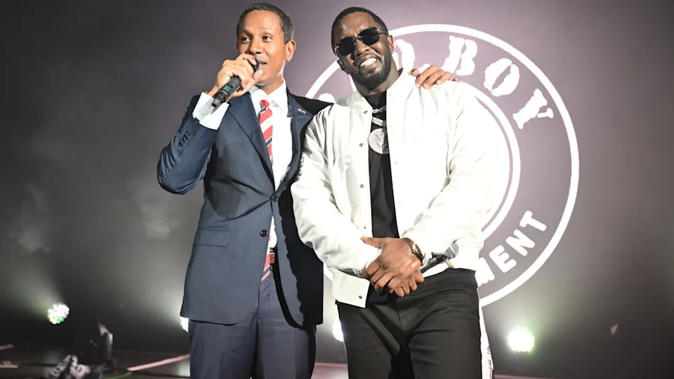 Shyne in a suit with a microphone, Diddy in sunglasses and a white jacket. Bad Boy Entertainment logo in the background.