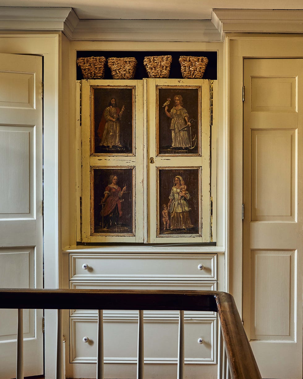Decorative cabinet with painted panels displaying historical figures, topped with woven baskets. Decorative cabinet with painted panels displaying historical figures, topped with woven baskets.