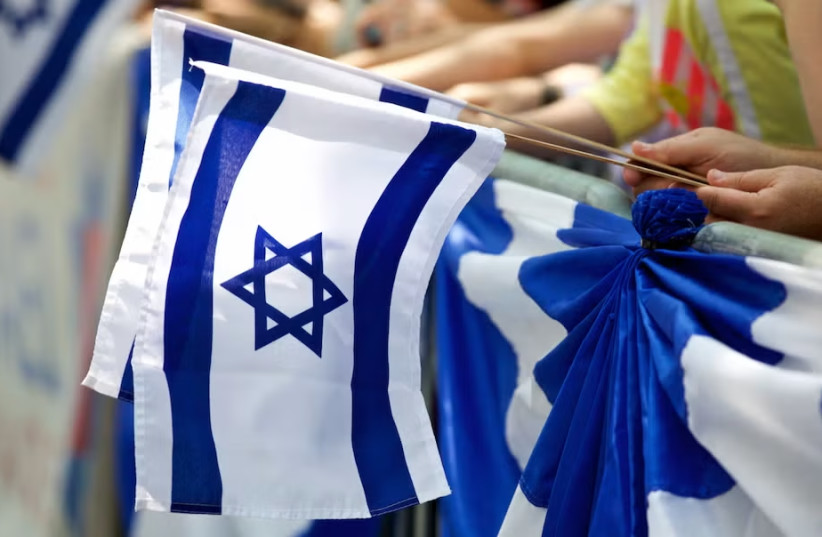 Marchers carry Israeli flags during the Celebrate Israel Parade, June 2, 2019.