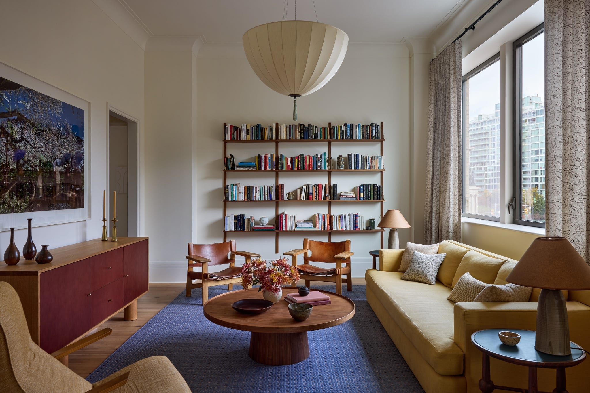 Inviting living room with modern decor and bookshelves.