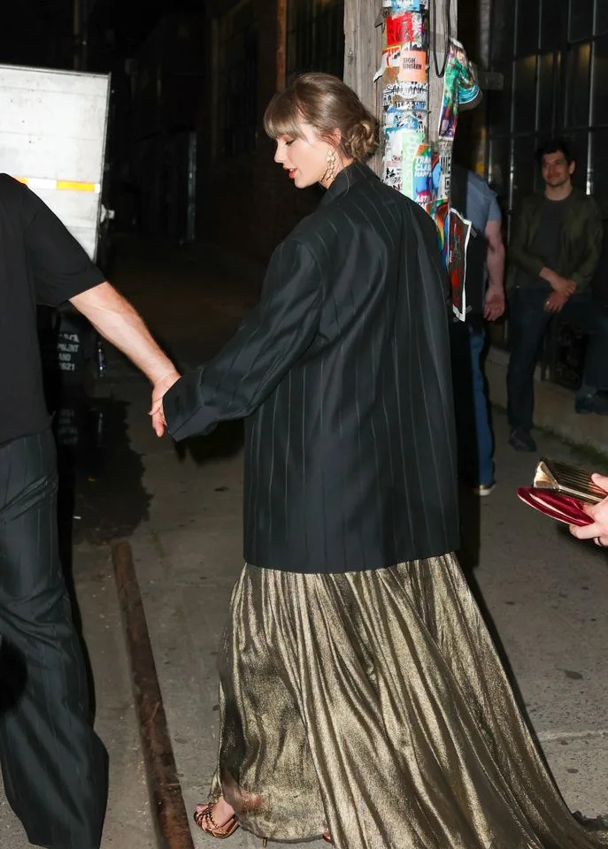 Taylor Swift wearing Travis Kelce's Fear of God blazer.Credit: Getty