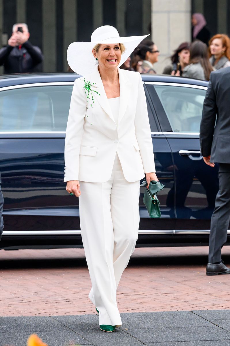 Queen Máxima paired the monochromatic ensemble with an oversized white hat that added drama and couture-inspired glamour to the clean silhouette