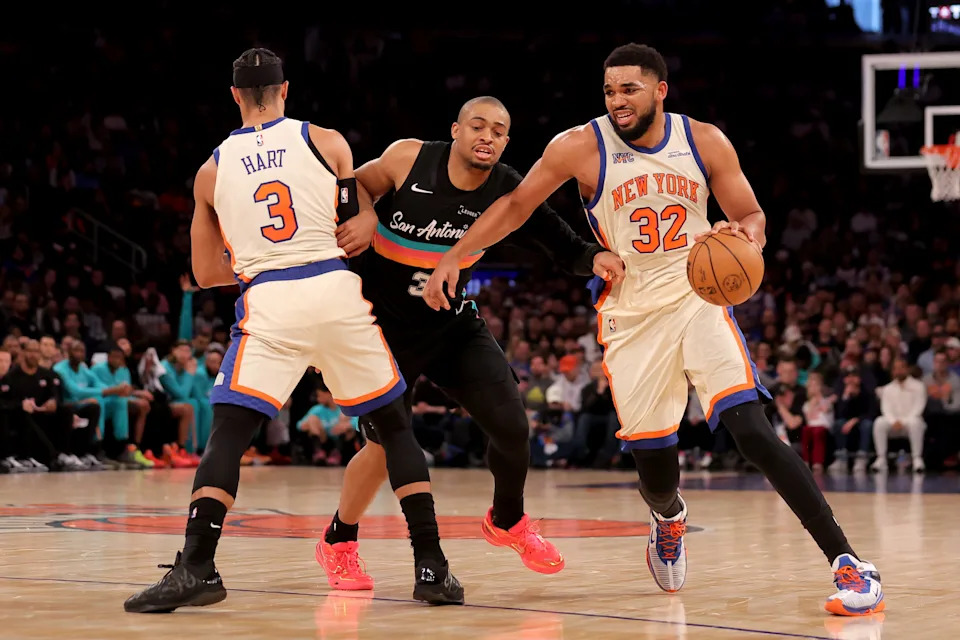 New York Knicks center Karl-Anthony Towns (32) dribbles around San Antonio Spurs forward Keldon Johnson (3) as Knicks guard Josh Hart (3) sets a pick.