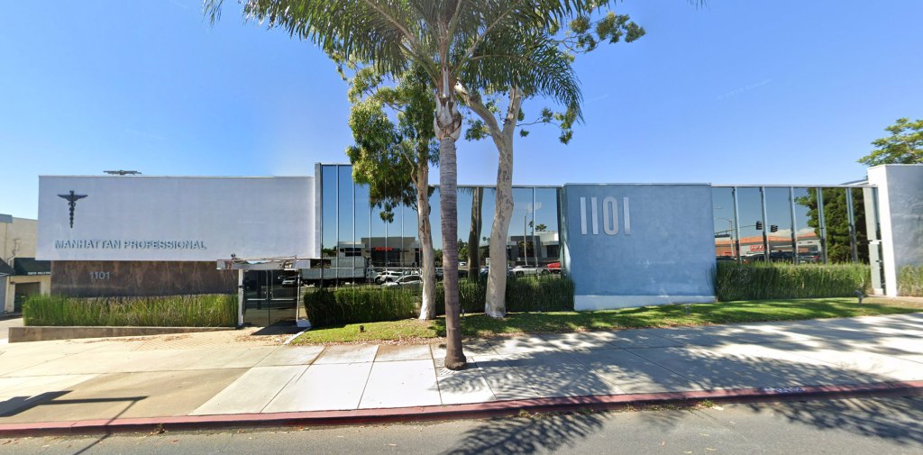 Exterior view of Neuro Wellness Spa at 1101 N Sepulveda Blvd, Manhattan Beach, CA, a white building with "MANHATTAN PROFESSIONAL" text and a Caduceus symbol, alongside glass windows, palm trees, and hedges.