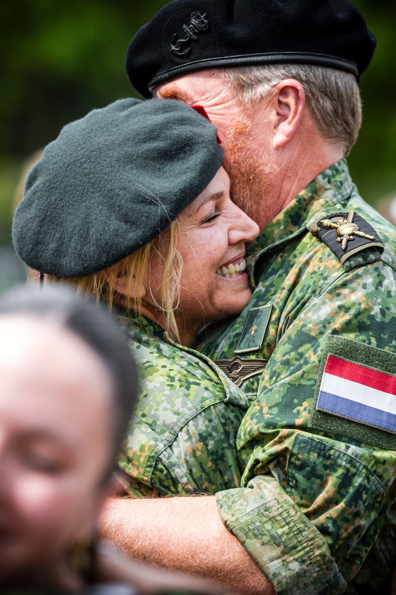 Queen Máxima shares a heartfelt hug with King Willem-Alexander as the royal family celebrates her military milestone.