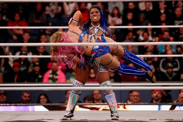 ROH Women's World Champion Athena lifts Mina Shirakawa in the ring and under the roof of Louis Armstrong Stadium in Flushing NY on May 24, 2026 during a live televised broadcast of AEW Pay Per View Double or Nothing. (Photo by Andrew Schwartz)