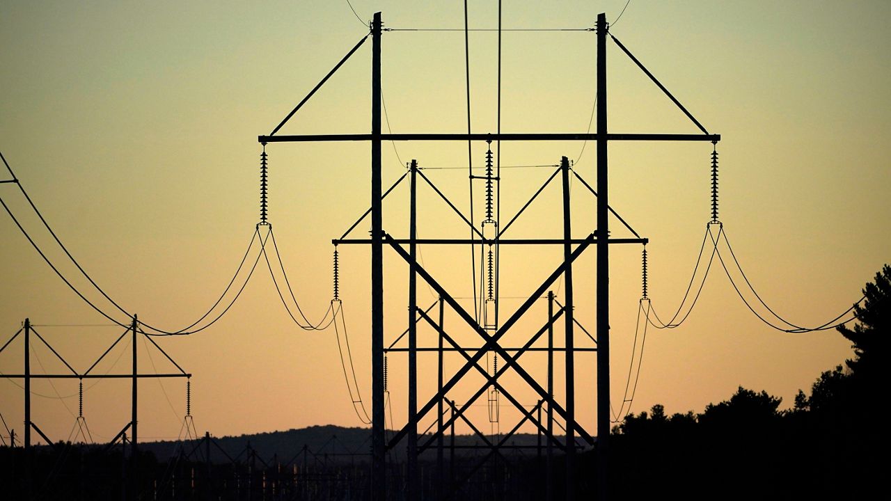 Central Maine Power transmission lines stretch above the treetops in Pownal in 2021