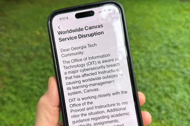 An image of a notice sent by Georgia Tech's information technology department warning students, professors and staff about the cybersecurity breach of the Canvas system it uses for assignments and grading is displayed on a phone, Friday, May 8, 2026, in Decatur, Georgia. (AP Photo/Michael Warren)