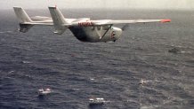 FILE - A Brothers to the Rescue plane flies over The Democracy Movement flotilla at the twelve-mile limit north of Havana, Cuba, July 10, 1999. (AP Photo/Alan Diaz, File)
