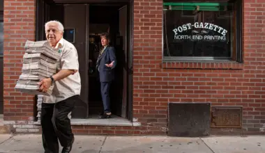 This photo provided by Ann Hermes shows Louie Graffeo delivering copies of The Post-Gazette for his girlfriend, publisher and editor, Pamela Donnaruma, in Boston on June 8, 2023. Photo: Ann Hermes via AP