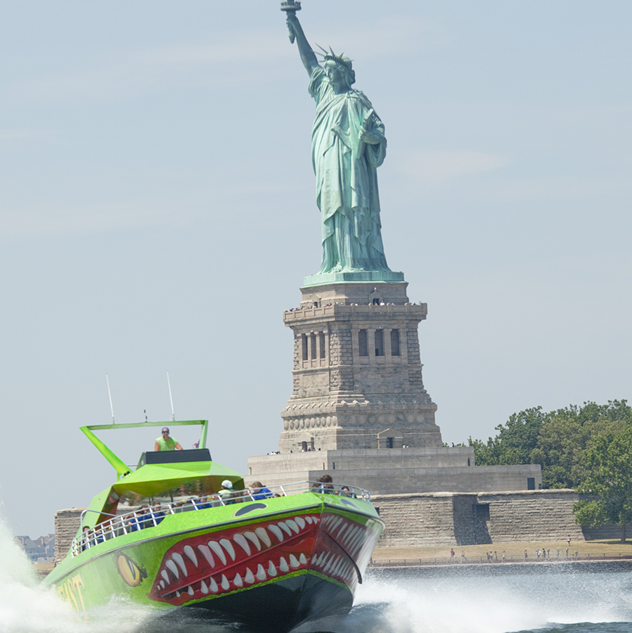 THE BEAST green speedboat near statue of liberty