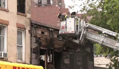 fireneb outside a building on a crane near damaged building