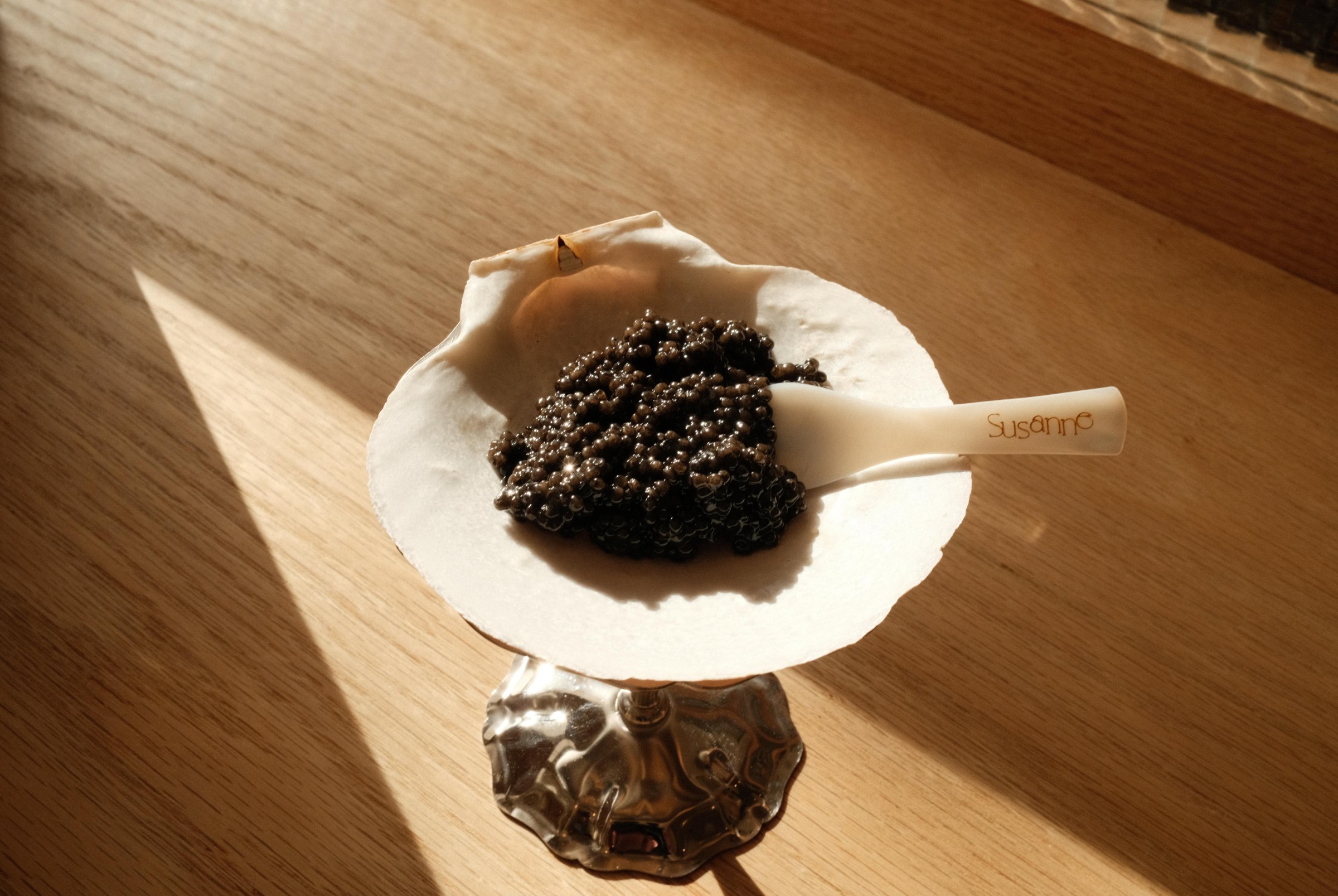 Black caviar on a clam shell.